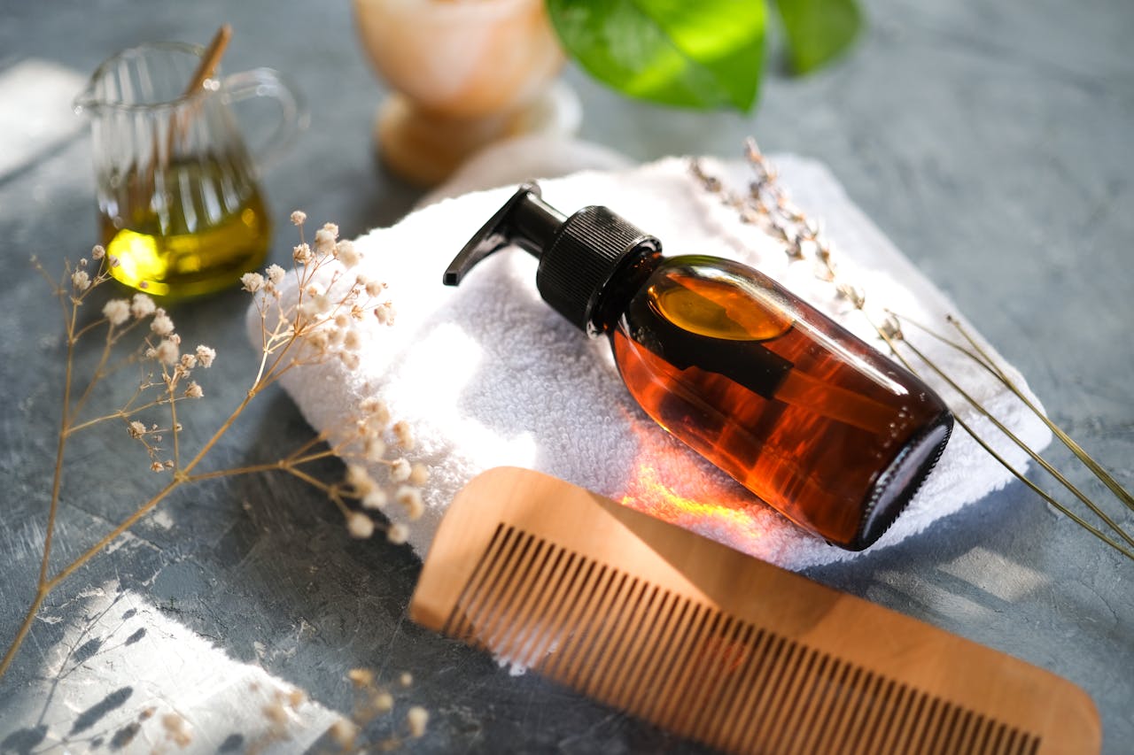 services-01 Elegant display of hair care accessories with natural elements and a wooden comb.